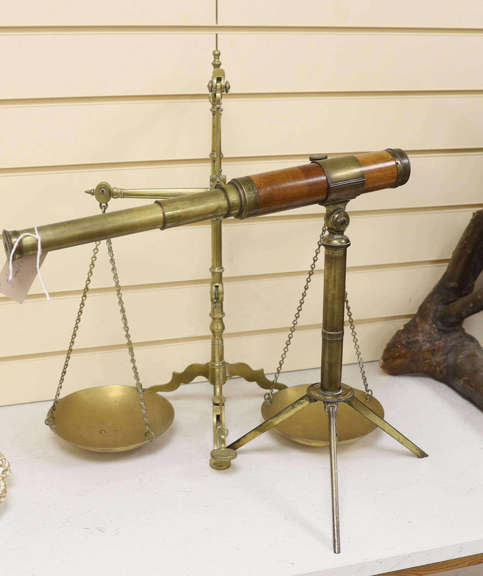 A telescope on tripod stand and a Doyle brass balance, largest 55cm high